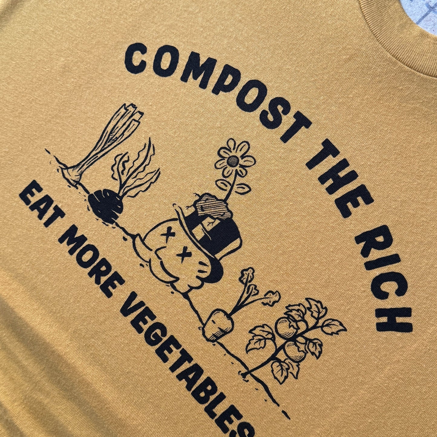 t-shirt with COMPOST THE RICH and EAT MORE VEGETABLES with drawn graphics