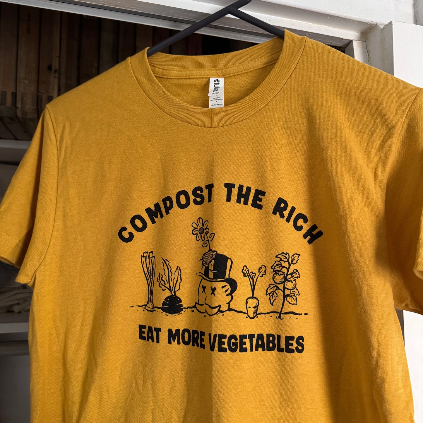 Yellow t-shirt with black text and graphics on a white background