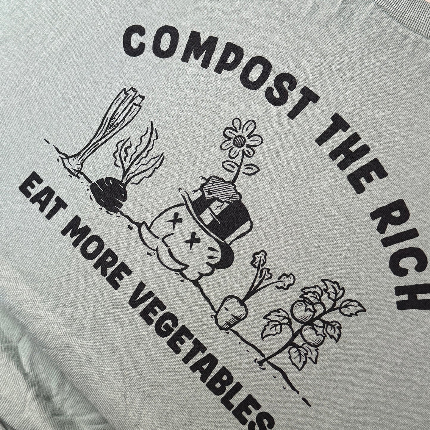green shirt with compost-themed graphic and text on a printing press.