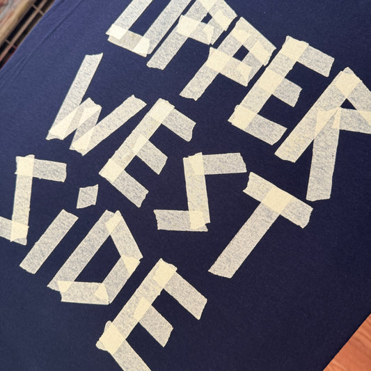 masking tape print on a shirt saying UPPER WEST SIDE from New York City