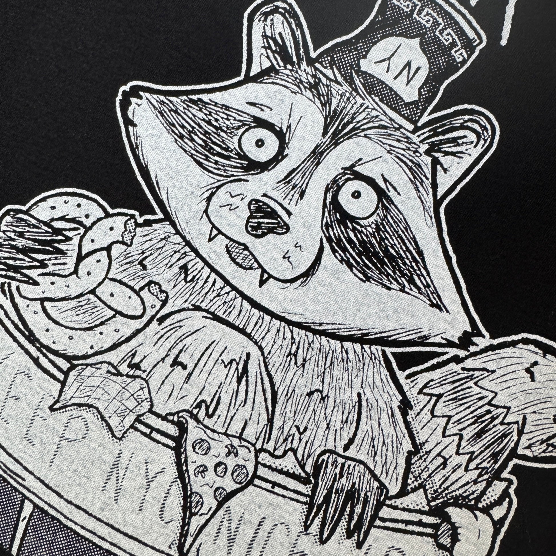 Black and white illustration of a raccoon in a New York City trash can on a dark t-shirt