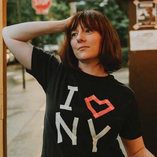 Woman wearing a I masking tape heart NY printed black t-shirt