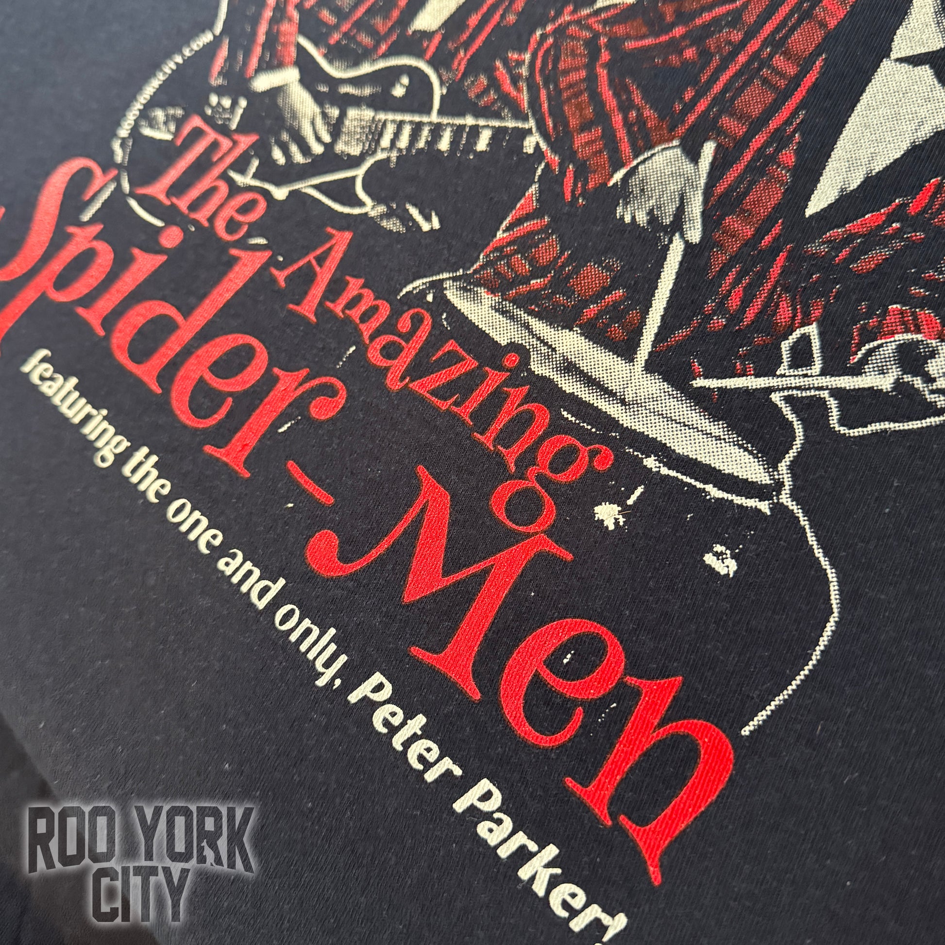 Image of the 3 Spider-Man actors put together as a rock band in red plaid suits with guitars, featuring text 'Multi World Tour' hand printed on a dark t-shirt.